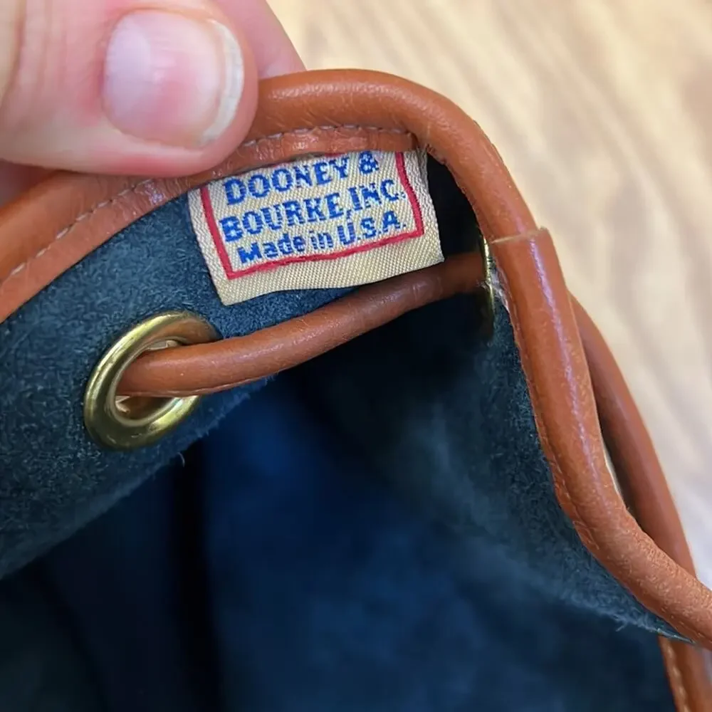 Dooney & Bourke tassel bucket bag blue pebbled leather tan accent gold hardware